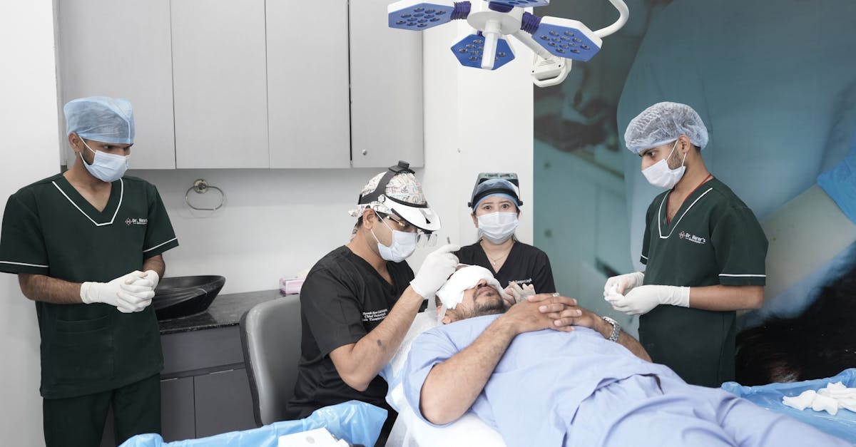Medical professionals conducting a hair transplant in a clinic setting.