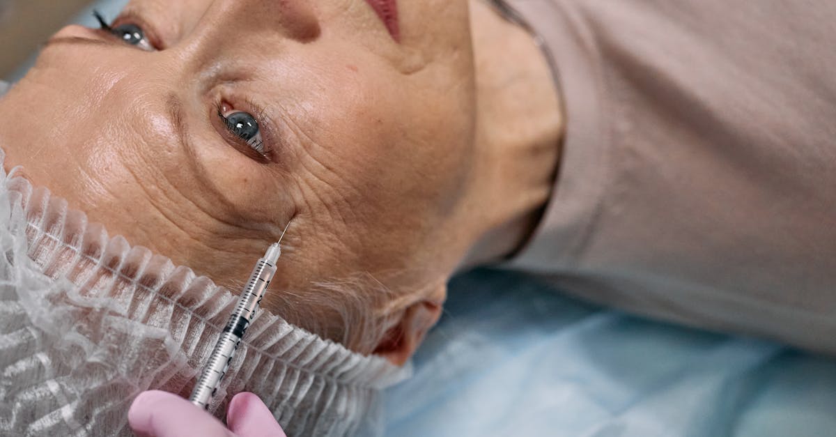 A senior woman undergoes a cosmetic injection procedure in a medical facility.